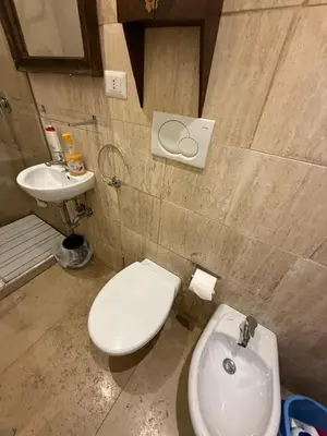 a bathroom with a white toilet and a sink at Green Loft di Trastevere in Rome