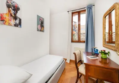a bedroom with a desk and a bed and a table at Luxury in Rome Panoramic terrace Fontana di Trevi in Rome