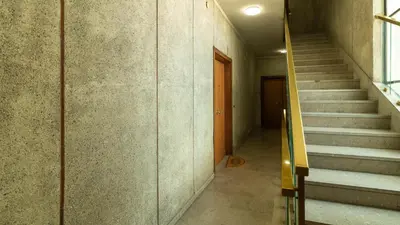 a hallway with stairs in a building with a door at Casa vacanza Appartamento Irnerio vicino la Metro in Rome