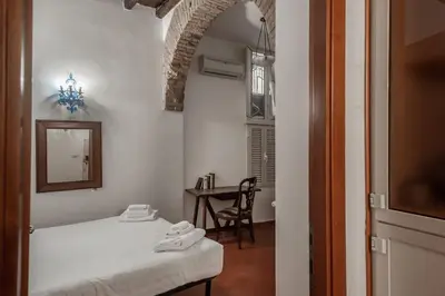a bedroom with a bed and a table with a mirror at Appartamento Castel Sant'Angelo in Rome
