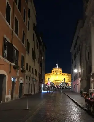a city street at night with a building in the background at Appartamento Castel Sant'Angelo in Rome