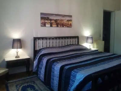 a bedroom with a large bed with two lamps at The Pope's Room in Rome