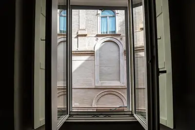 an open window with a view of a building at Roma apartments in Rome