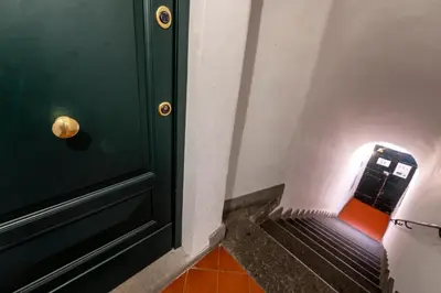a green door with a bench next to it at Roma apartments in Rome