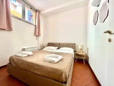 a bedroom with a bed with towels on it at Linda Charme in Rome