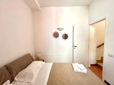 a bedroom with a bed and a lamp and a door at Linda Charme in Rome