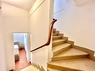 a staircase leading to a room with a bedroom at Linda Charme in Rome
