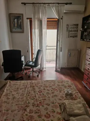 a bedroom with a bed and a desk and a chair at 5 metro stop colosseum in Rome