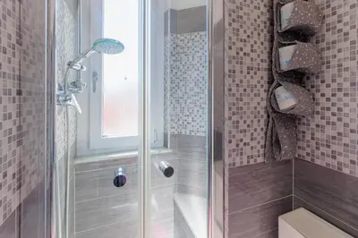 a shower with a glass door in a bathroom at 10 Min Colosseum, PreNestInHome - Renovated 2024 Apartment, P igneto , Self Check-in h24 in Rome