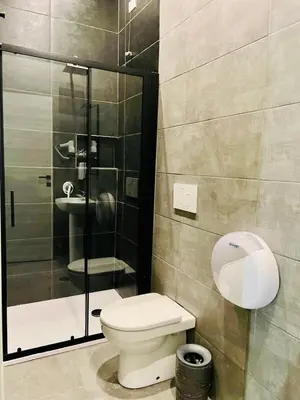 a bathroom with a toilet and a glass shower at Jupiter Home in Rome