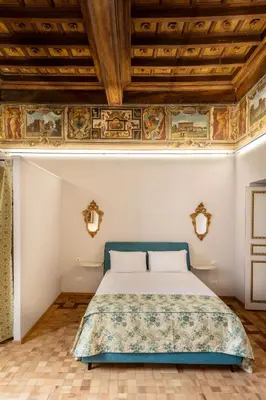a bedroom with a bed and a wooden ceiling at Casa Paolina, Burghesius homes in Rome
