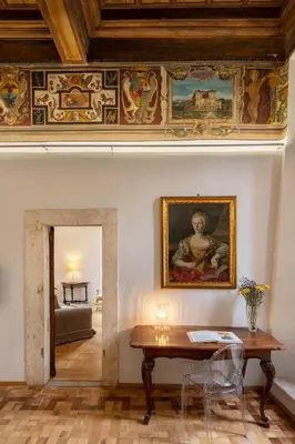 a room with a table and a painting on the wall at Casa Paolina, Burghesius homes in Rome