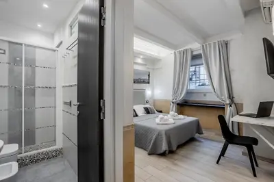 a bedroom with a bed and a chair in a room at Vatican Sweet Dreams Apartment in Rome