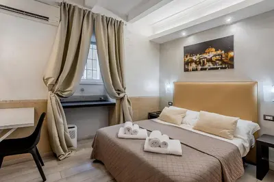 a bedroom with a bed with two towels on it at Vatican Sweet Dreams Apartment in Rome