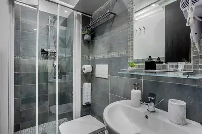 a bathroom with a sink and a shower and a toilet at Vatican Sweet Dreams Apartment in Rome