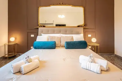 a large bed with towels on it with a mirror at Exclusive View Rome I Residenza di Prestigio I 5 min metro Colosseo in Rome