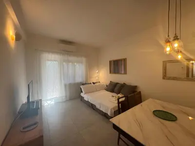 a bedroom with a bed and a couch and a table at Urban Oasis with Garden in Rome