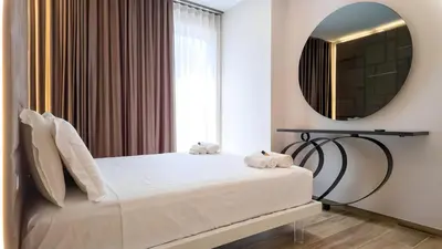 a bedroom with a bed and a mirror at Soggiorno Chic , 2 Camere Vicino Colosseo e Metro in Rome