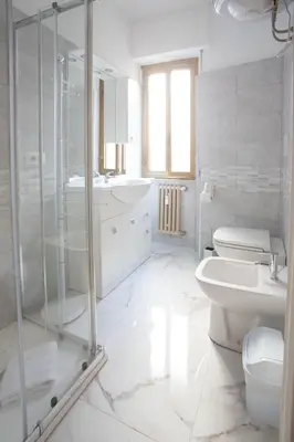 a white bathroom with a shower and a toilet and a sink at VI Domus - Vatican Museum Guest House - Roma in Rome