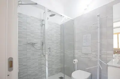a bathroom with a glass shower with a toilet at VI Domus - Vatican Museum Guest House - Roma in Rome
