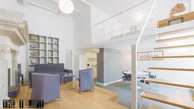 a living room with a table and blue chairs at Trastevere Loft in Rome