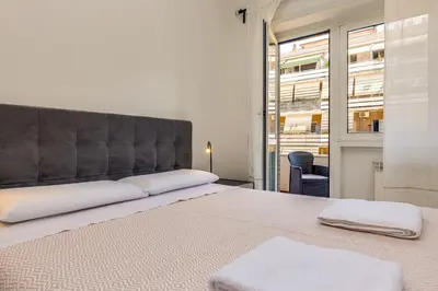 a bedroom with a large bed with white towels on it at Pica's House in Rome