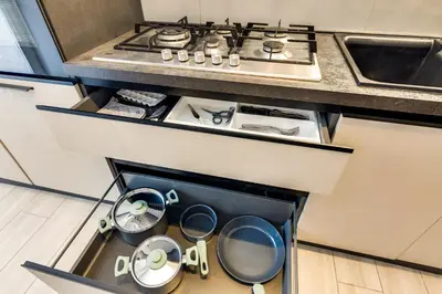 an open drawer in a kitchen with pots and pans at Pica's House in Rome