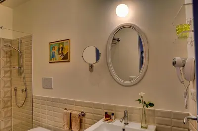 a bathroom with a sink and a mirror at Casa Sotgiu Guest House in Rome