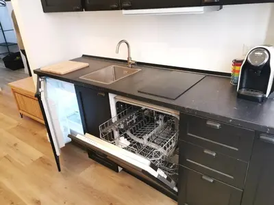 an open dishwasher in a kitchen with a sink at Casa D'Agata in Rome
