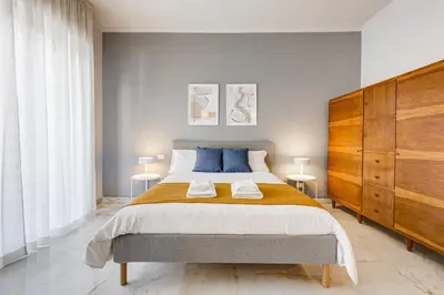 a bedroom with a large bed and two tables at FaMa - Quiet&Bright 2BR Apartment in Rome