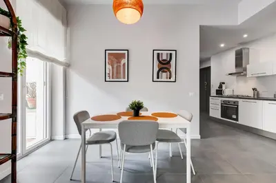 a white dining room with a table and chairs at FaMa - Quiet&Bright 2BR Apartment in Rome