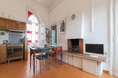 a kitchen with a table and chairs and a television at Casa di Cosimo - WelcomeToRhome in Rome