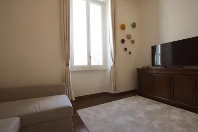 a living room with a couch and a flat screen tv at La Finestra sulla Basilica in Rome