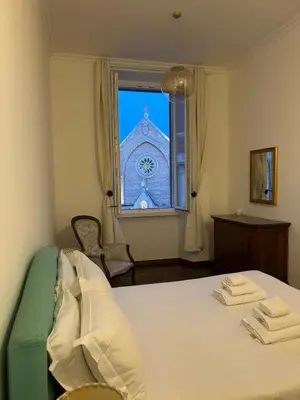 a bedroom with a bed and a window with a building at La Finestra sulla Basilica in Rome