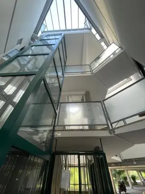 an escalator in a building with a glass ceiling at Olimpic Sunny room in Rome