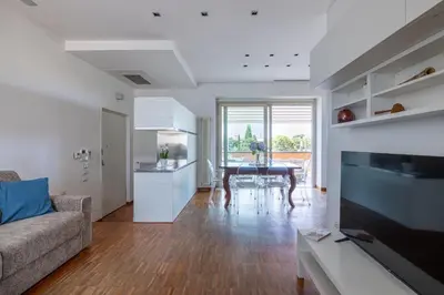 a living room with a couch and a table at Nostromondo BIANCAMANO ATTIC - Stylish penthouse with private terrace- San Giovanni in Rome