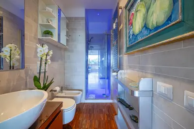 a bathroom with a sink and a toilet and a shower at Nostromondo BIANCAMANO ATTIC - Stylish penthouse with private terrace- San Giovanni in Rome