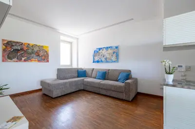 a living room with a couch in the middle at Nostromondo BIANCAMANO ATTIC - Stylish penthouse with private terrace- San Giovanni in Rome