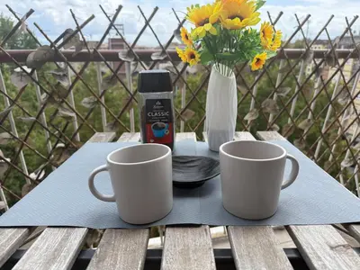 a table with two coffee mugs and a bottle ofresso at Sunflower House in Rome