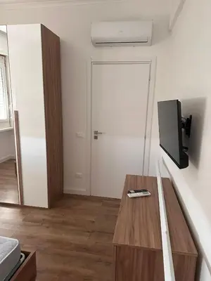 a room with a table and a door with a tv at Sunflower House in Rome