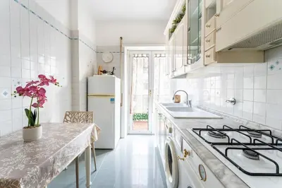 a kitchen with a sink and a stove at 7th Floor Terrace Stay - San Giovanni & Colosseum in Rome