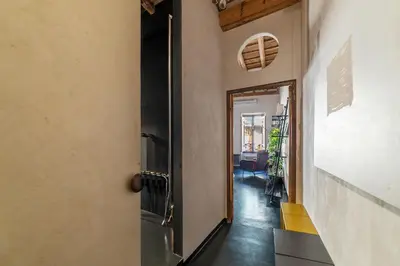 a hallway with a door leading to a living room at GuestHost - Vintage-Modern Apartment Trastevere in Rome