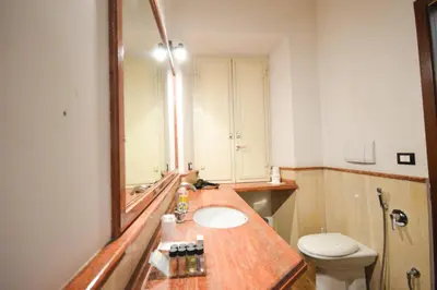 a bathroom with a sink and a mirror and a toilet at Guest House Planet 29 in Rome