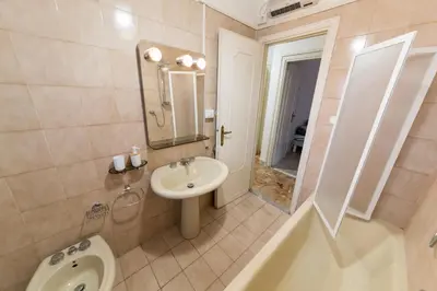 a bathroom with a sink and a toilet at raffaele affittacamere guesthouse in Rome