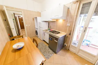a small kitchen with a wooden table and a table and a tableablish at raffaele affittacamere guesthouse in Rome
