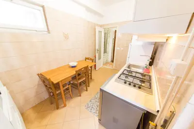 a small kitchen with a table and a stove at raffaele affittacamere guesthouse in Rome