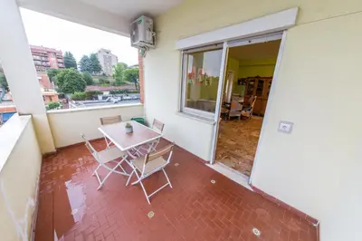a patio with a table and chairs on a balcony at raffaele affittacamere guesthouse in Rome