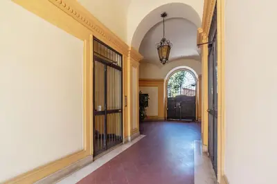 a hallway of a house with an entry way with a chandelier at GuestHost - San Pietro Studio Apartment Roma in Rome