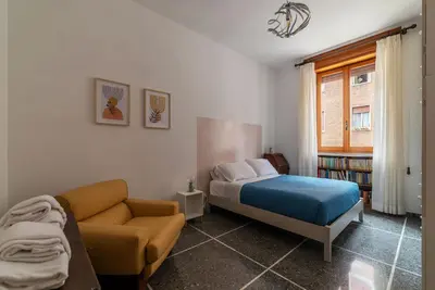 a bedroom with a bed and a couch and a window at Casa Luisa - WelcomeToRhome in Rome