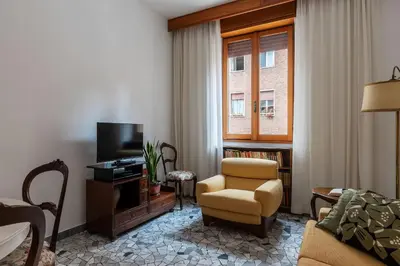 a living room with a couch and a chair and a television at Casa Luisa - WelcomeToRhome in Rome